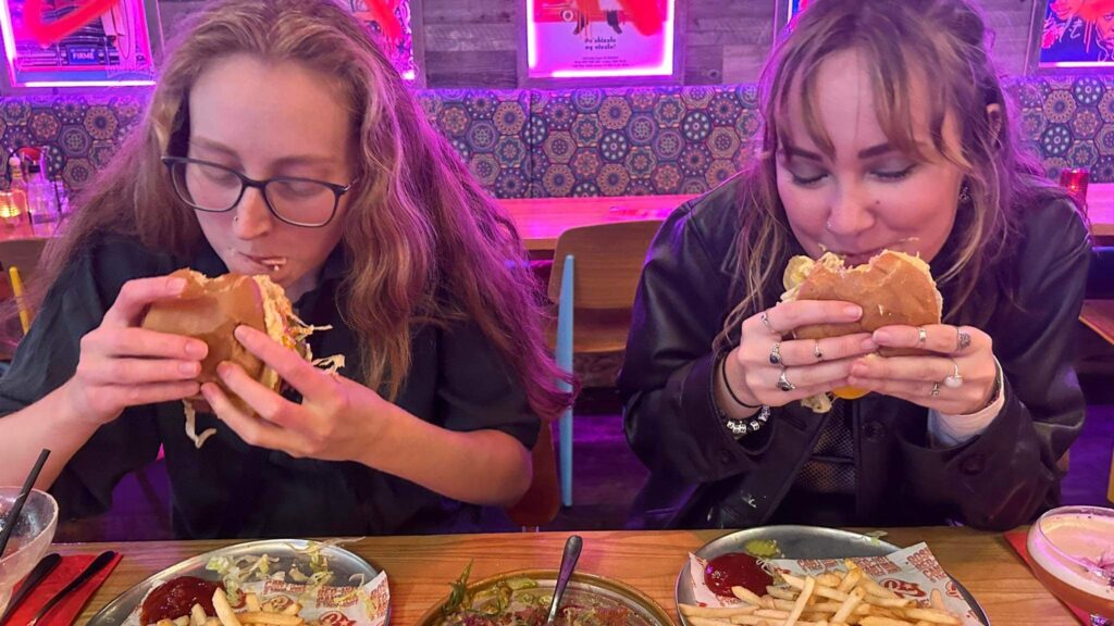 Ashley and Gabby eating a vegan burger at rosies