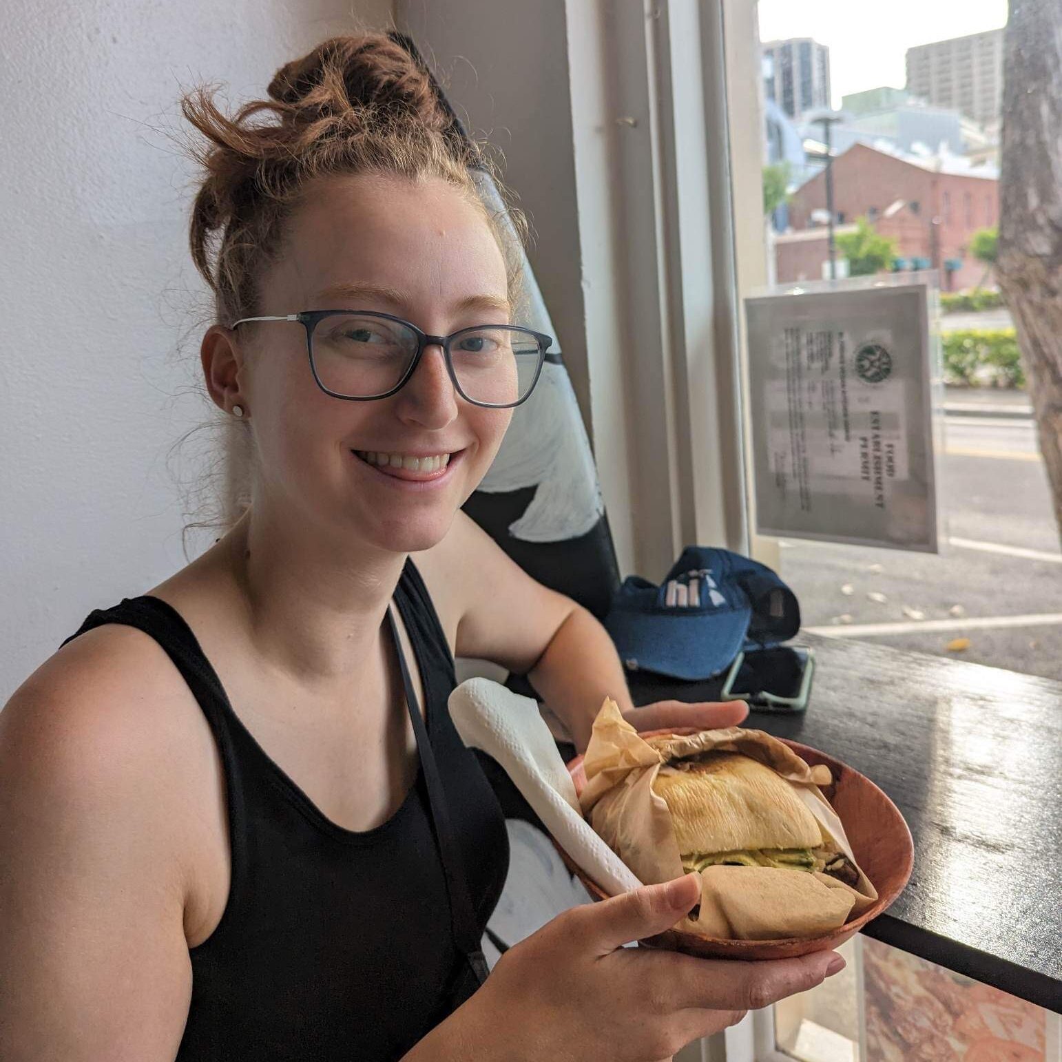 Ashley eating a burger at blondies vegan kitchen