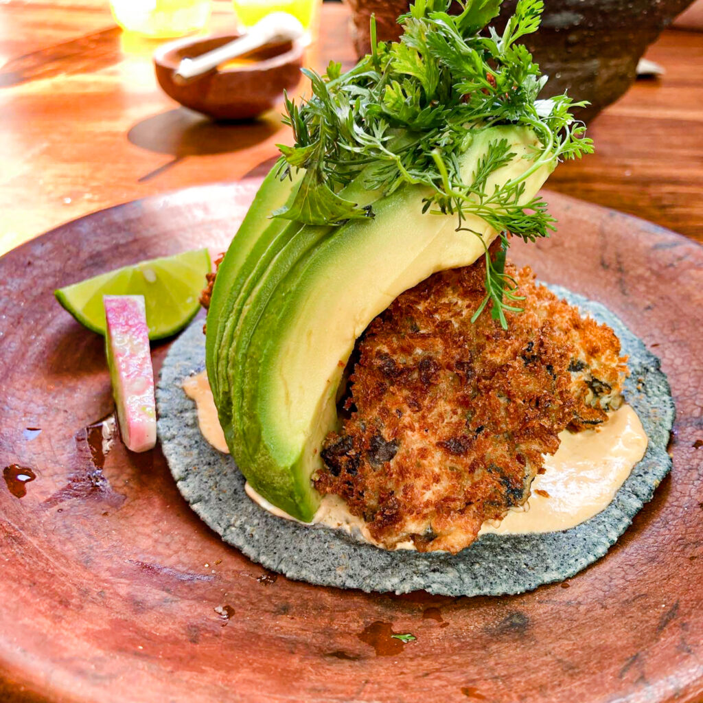 Mushroom taco with avocardo and lime wedges