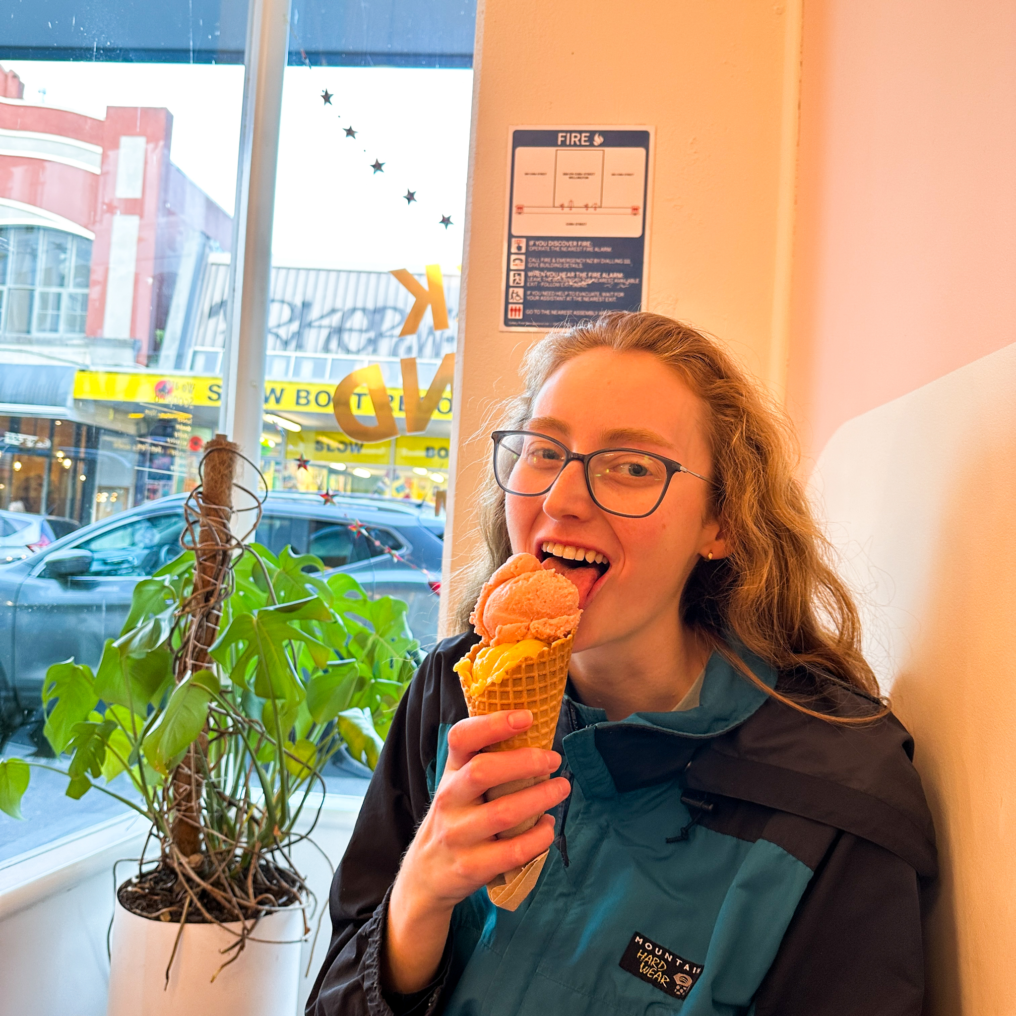 Ashley eating a vegan mango ice cream in a cone from duck island