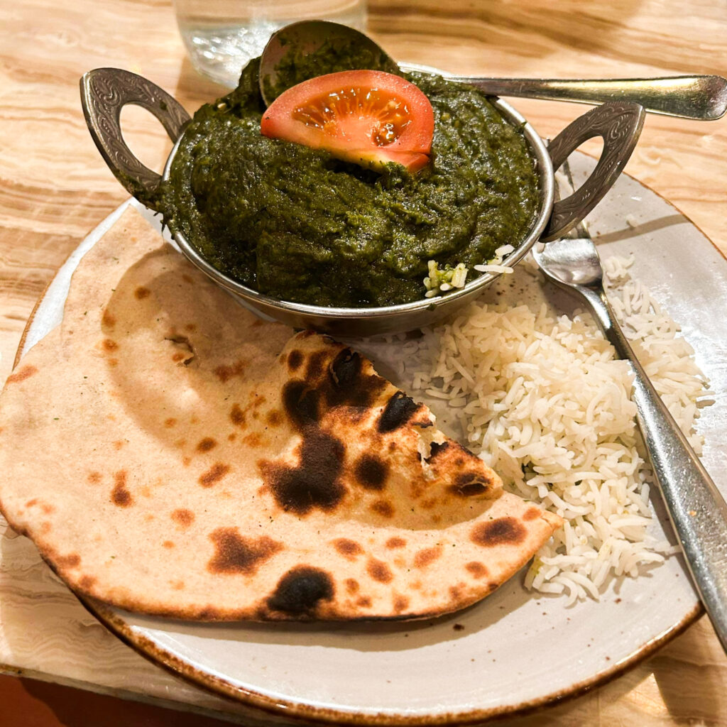 Naan with vegan Indian curry and rice - Corianders Indian Restaurant Christchurch